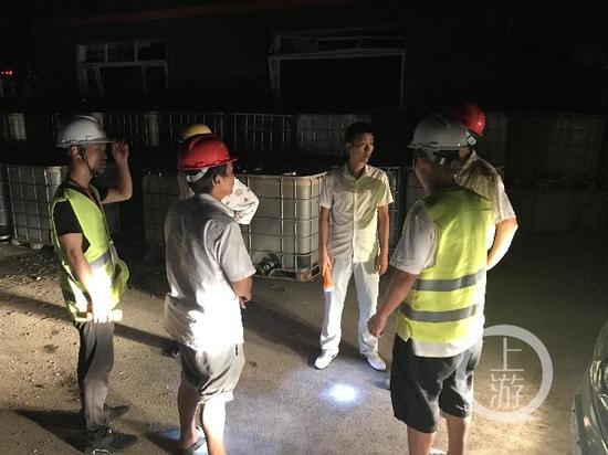 ▲环保局工作人员在场讨论关于如何抽污水的问题。