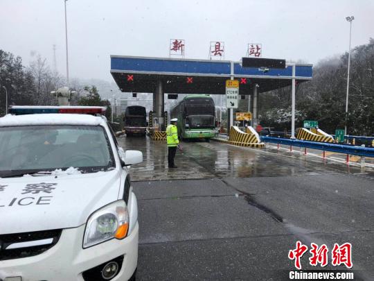 图为信阳新县高速收费站出站口,交警引导大客车出站。 刘瑞 摄