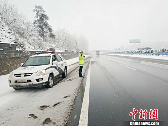 图为交警值守路边,随时监控突发状况。 刘瑞 摄