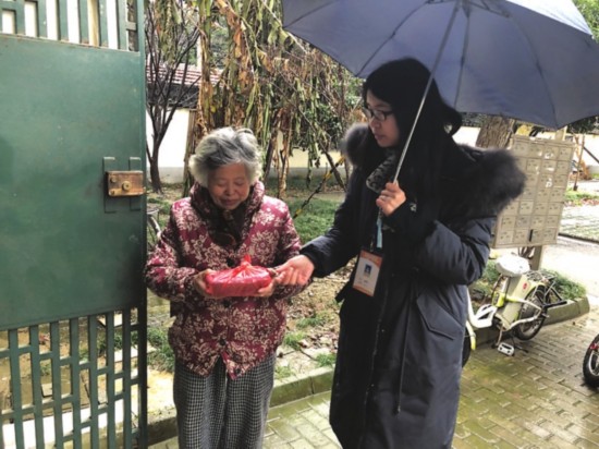 　　③金阊街道彩香二村北社区社工冒雨为老人送粥。图片由社区提供