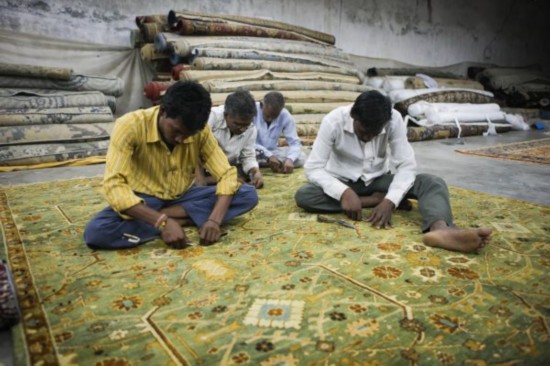 资料图:印度北方邦城市珀多希的一家手工地毯工厂里的工人们正在加工即将完成的地毯。新华社记者郑焕松摄