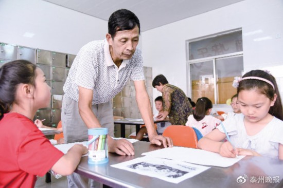 王老师在指导学生作画。