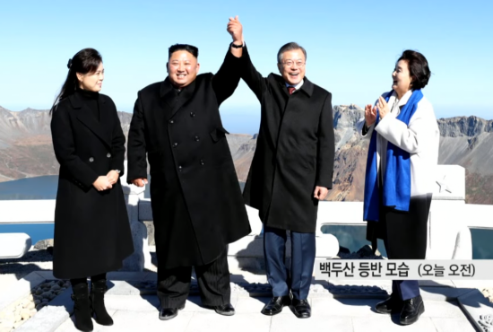 2018年9月,金正恩与文在寅在天池前牵手合影。(韩国YTN电视台)