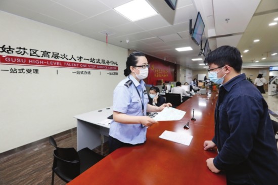 　　昨日，申请人辛昌坤在姑苏区行政服务中心拿到了我市发出的首张人才落户户籍“准迁证”。　□记者　张健　摄