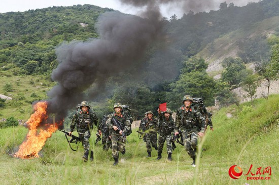 官兵在某山地开展班组战术演练。