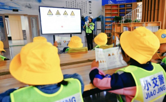 民警为学生们讲解交通标志。刘劲毅摄