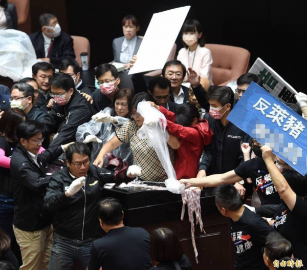 苏贞昌上发言台，国民党团拿猪内脏、猪皮泼在发言台上。图自&ldquo;自由时报&rdquo;