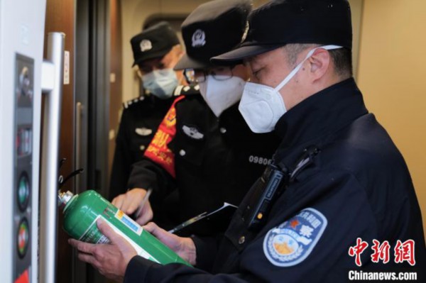 图为王聪在G320次列车始发前检查车厢消防设备。　陈文 摄