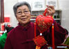 Wang Xiuying displays a herbal sachet at a workshop in the wetland park of Pan'anhu lake, in Xuzhou, east China's Jiangsu Province, Jan. 17, 2018. Wang, an 80-year-old craftswoman is renowned for making herbal sachets. Combining tradition with bold innovation, many of her works were granted with prizes and gained widespread reputation for her. Her hand-made works were labeled as masterpieces of Xuzhou scented sachets, a national intangible cultural heritage. Under the guidance of Wang, hundreds of local women started to make sachets to increase their income. (Xinhua/Ji Chunpeng)