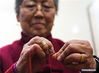 Wang Xiuying threads a needle at a workshop in the wetland park of Pan'anhu lake, in Xuzhou, east China's Jiangsu Province, Jan. 17, 2018. Wang, an 80-year-old craftswoman is renowned for making herbal sachets. Combining tradition with bold innovation, many of her works were granted with prizes and gained widespread reputation for her. Her hand-made works were labeled as masterpieces of Xuzhou scented sachets, a national intangible cultural heritage. Under the guidance of Wang, hundreds of local women started to make sachets to increase their income. (Xinhua/Ji Chunpeng)