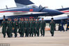 2018年11月4日，珠海国际航展中心，中国空军“八一”飞行表演队的队员，从表演战机前走过。