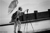 台风“海葵”袭杭，一位摄影爱好者仍坚持守候在断桥上，捕捉生动的画面。
