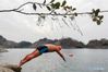 A winter swimmer dives into water in a park in Xuyi County of east China's Jiangsu Province, Dec. 11, 2018. (Xinhua/Zhou Haijun)