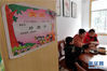 2月13日，在江西省南昌市新建区建设路社区，胡海红在家里陪两个孩子一起吃饭，墙上贴着儿子熊理超在学校获得的奖状。
