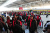 2018年2月8日，在安徽阜阳火车站，返乡农民工从宁波发往阜阳的免费专列上走下后，在青年志愿者的引导下排着长队出站。