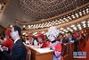 3月5日，第十三届全国人民代表大会第一次会议在北京人民大会堂开幕。这是代表们在认真听会。 新华社记者 李刚 摄