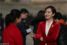 2018年3月5日，北京，女记者在人民大会堂外的广场上进行报道。当日上午9点，十三届全国人大一次会议开幕。
