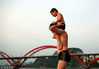 4岁半的男孩邓舜禹尧骑在父亲肩膀上玩跳水。