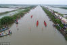 Contestants take part in a fish trap and a dragon boat race, Huai’an City, Jiangsu Province, June 16, 2018.
