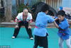 2018年7月17日，青岛。孩子们在黄师傅的指导下，练习摔跤。