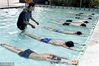 2018年7月22日，浙江金华，教练在武义县一游泳馆手把手教60多名中小学生游泳基本要领。