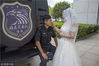 Taizhou, August 17, 2018. The bride-to-be of Ping An is wiping away his sweat. The three police officers Zhang Yichi, He Jie and Ping An are all getting married on the same day of Chinese Valentine’s Day—the 7th day of the 7th lunar month. This year, this day falls on August 17. Their fiancées, invited to have this field trip, are having a better understanding of the missions of the special force and celebrating this sweet holiday with a group wedding.

