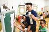Guo Xinwang prepares materials for teaching at the Xiaoxihu kindergarten in Nanjing, capital of east China's Jiangsu Province, Sept. 6, 2018. Guo, born in 1993 and graduated from the Jiangsu Normal University, became the first and only male teacher of the Xiaoxihu kindergarten three years ago. There are 400 plus male teachers in Nanjing nowadays, up to three percent of the whole teachers working in kindergartens. (Xinhua/Li Bo)