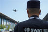 2018年09月14日，江苏省无锡市，一位特警正在场外调试无人机进行巡察。