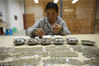 2019年1月10日，在贵州省丹寨县一家民族银饰加工坊内，一名技术工人在给银酒杯做装饰。