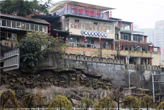 重庆一江湖菜馆建在崖顶 四周刻满吊脚楼浮雕