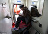 2014年2月6日13时25分，记者又从杭州东坐上由南宁开往上海的k538次列车，硬坐车厢人满为患，连车厢接处都挤满了持无座票的旅客。一名男士坐到了车厢接处的洗刷台上。