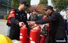 A police officer demonstrates the use of fire extinguisher during a fire awareness event in Nanjing, east China's Jiangsu Province, Nov. 8, 2019. (Xinhua/Ji Chunpeng)