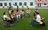 2009年4月25日，四川绵阳，“轮椅吉他队”队员的减少反而让盛雪老师很开心，因为坐在轮椅上的队员正在慢慢从音乐声中站起。常亮/视觉中国