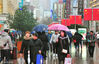 2019年2月10日，上海，当天是猪年新春长假的最后一天，申城又冷又湿，阴雨连绵。返程客遭遇恶劣天气,，回家的人拖着行李步履匆匆。南京路步行街头，路人游客打着雨伞在冷雨中行走，体感十分寒冷。据气象预报：未来10天申城都将是雨雪天气，但气温略有回升。杨奕/视觉中国