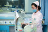 A nurse takes care of a bay in NICU at a hospital in Taizhou, East China’s Jiangsu province, March 8, 2019. [Photo/VCG]
The low female employment rate may also cause gender inequity because women would have lower status in the family and in society, he added.

He urged the government to take measures to reduce the conflict between work and caring for children to prevent the number of female workers from falling too drastically.

