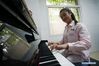 Zhou Wenqing plays the music composed by herself at the piano room in Nanjing Normal University of Special Education in Nanjing, East China's Jiangsu province, May 17, 2019. [Photo/Xinhua]