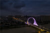 2019年7月19日，江苏淮安，夜幕降临，新通车的淮海南路运河桥上空乌云笼罩，从空中俯瞰大桥气势宏伟，造型奇特，灯光迷人。