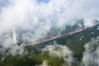 2019年7月24日，湖南省湘西土家族苗族自治州吉首市矮寨镇，航拍矮寨特大悬索桥周围云雾缭绕。