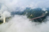
2019年7月24日，湖南省湘西土家族苗族自治州吉首市矮寨镇，航拍矮寨特大悬索桥周围云雾缭绕。