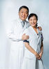Liu Dawei (L), director of critical care medicine department, and his wife Wang Wenfang, staff member of telemedicine center, pose for a photo at their work place of the Peking Union Medical College Hospital in Beijing, capital of China, Aug. 13, 2019. China has about 3.6 million qualified physicians and 4.1 million registered nurses. 