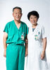 Ren Hongzhi (L), chief physician of anesthesiology department, and his wife Xu Ling, chief physician of gynaecology and obstetrics department, pose for a photo at their work place of the Peking Union Medical College Hospital in Beijing, capital of China, Aug. 13, 2019.