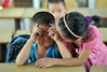 2012年9月3日，广东东莞，一年级的农永志哭了，二年级的姐姐安慰他。梁清/视觉中国
