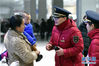 1月15日，在蚌埠站候车大厅内，刘凤敏（右二）带着徒弟为旅客提供服务。新华社发（周牧 摄）