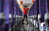1月22日，银中高铁中卫南站，保洁员周鲜花在停车间隙清洁列车车厢。