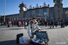 Mr Ji, who has been working in Beijing for three years, shows nuts as gifts for his family at the Beijing Railway Station in Beijing, capital of China, Jan 20, 2020. 