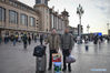 Passengers Ni Jianxin(R) and Chen Hanchang from East China's Jiangsu province pose for photos with the gifts for their families at the Beijing Railway Station in Beijing, capital of China, Jan 14, 2020. Passengers always take carefully selected gifts for their beloved families as they head home during the Spring Festival travel rush. [Photo/Xinhua]