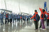 Medical staffers from east China's Shandong Province (L) wave to their peers from east China's Jiangsu Province at the Wuhan Tianhe International Airport, in Wuhan, central China's Hubei Province, March 17, 2020. Some medical assistance teams started leaving Hubei Province on Tuesday as the epidemic outbreak in the hard-hit province has been subdued. (Xinhua/Xiong Qi)