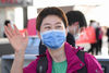 A medical staffer from northwest China's Xinjiang Uygur Autonomous Region waves goodbye to people seeing them off at the Wuhan Tianhe International Airport, in Wuhan, central China's Hubei Province, March 17, 2020. Some medical assistance teams started leaving Hubei Province on Tuesday as the epidemic outbreak in the hard-hit province has been subdued. (Xinhua/Chen Yehua)