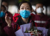Medic Zhang Durong from southwest China's Guizhou Province waves goodbye at Wuhan Railway Station in central China's Hubei Province, March 17, 2020. Some medical assistance teams started leaving Hubei Province on Tuesday as the epidemic outbreak in the hard-hit province has been subdued. (Xinhua/Xiao Yijiu)