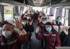 Medics from southwest China's Guizhou Province wave goodbye on a bus in Wuhan, central China's Hubei Province, on March 17, 2020. Some medical assistance teams started leaving Hubei Province on Tuesday as the epidemic outbreak in the hard-hit province has been subdued. (Xinhua/Xiao Yijiu)